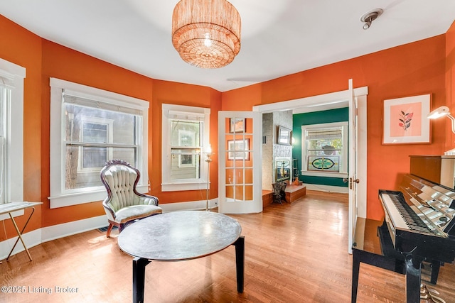 1830 Edgeland Ave, Louisville, KY 40204 - sitting room featuring wood finished floors, baseboards, and a chandelier