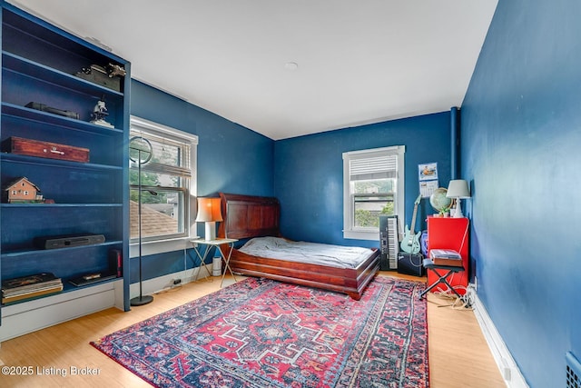1830 Edgeland Ave, Louisville, KY 40204 - bedroom featuring multiple windows and wood finished floors