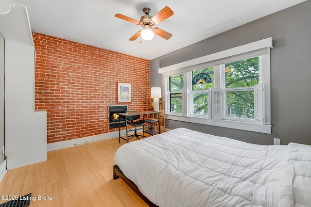 1830 Edgeland Ave, Louisville, KY 40204 - bedroom with brick wall, baseboards, wood finished floors, and a ceiling fan