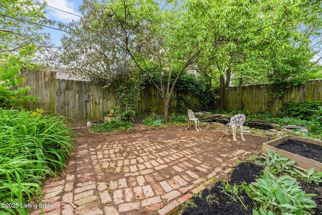 1830 Edgeland Ave, Louisville, KY 40204 - view of patio / terrace with a fenced backyard and a vegetable garden