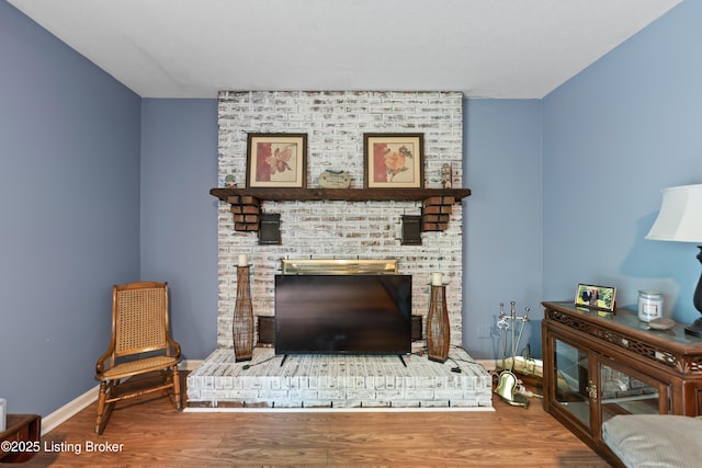 11310 Corston Ct, Louisville, KY 40241 - living area featuring wood finished floors, a brick fireplace, and baseboards