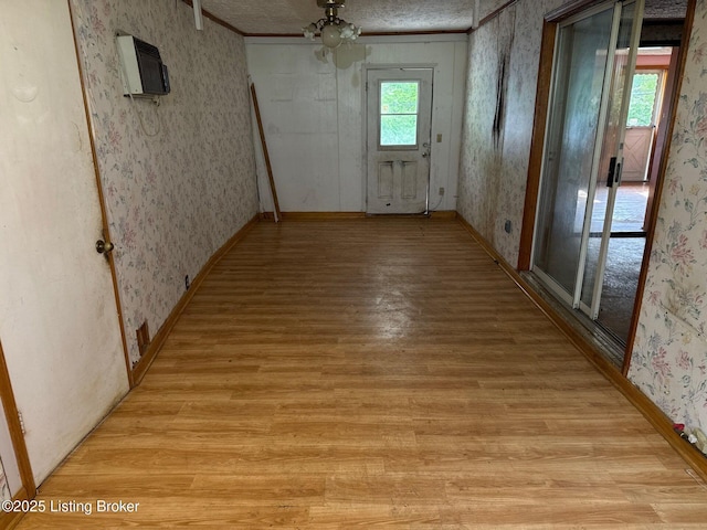 corridor featuring wallpapered walls and light wood-style floors