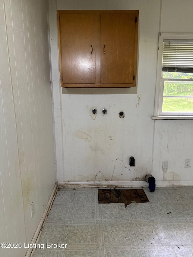laundry room featuring cabinet space and tile patterned floors