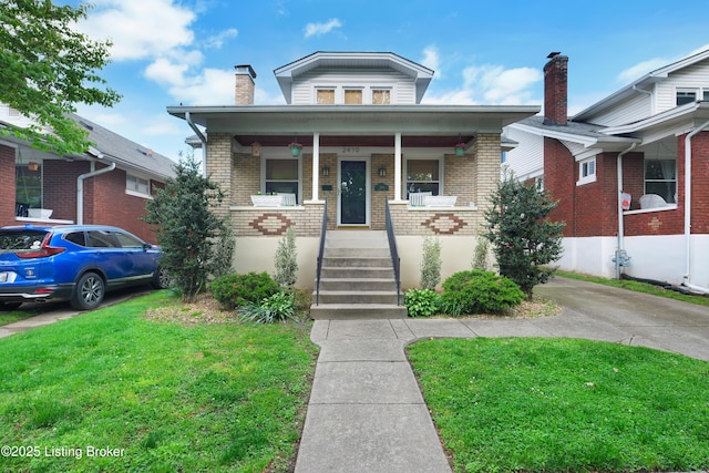 2410 Sherry Rd, Louisville, KY 40217 - bungalow-style home with brick siding, a porch, a chimney, and a front yard