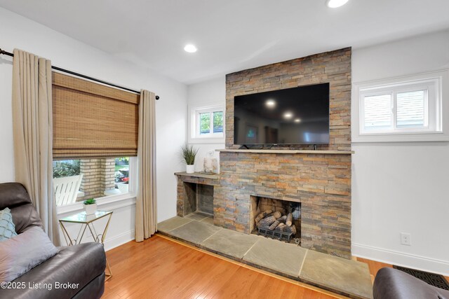 2410 Sherry Rd, Louisville, KY 40217 - living room with wood finished floors, baseboards, a fireplace, and recessed lighting