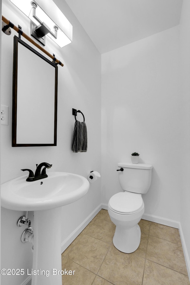 2410 Sherry Rd, Louisville, KY 40217 - bathroom featuring baseboards, toilet, and tile patterned flooring