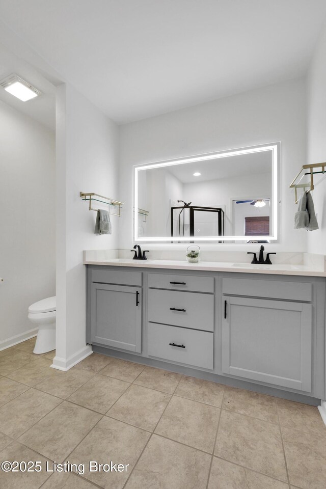 2410 Sherry Rd, Louisville, KY 40217 - bathroom featuring double vanity, tile patterned floors, and toilet