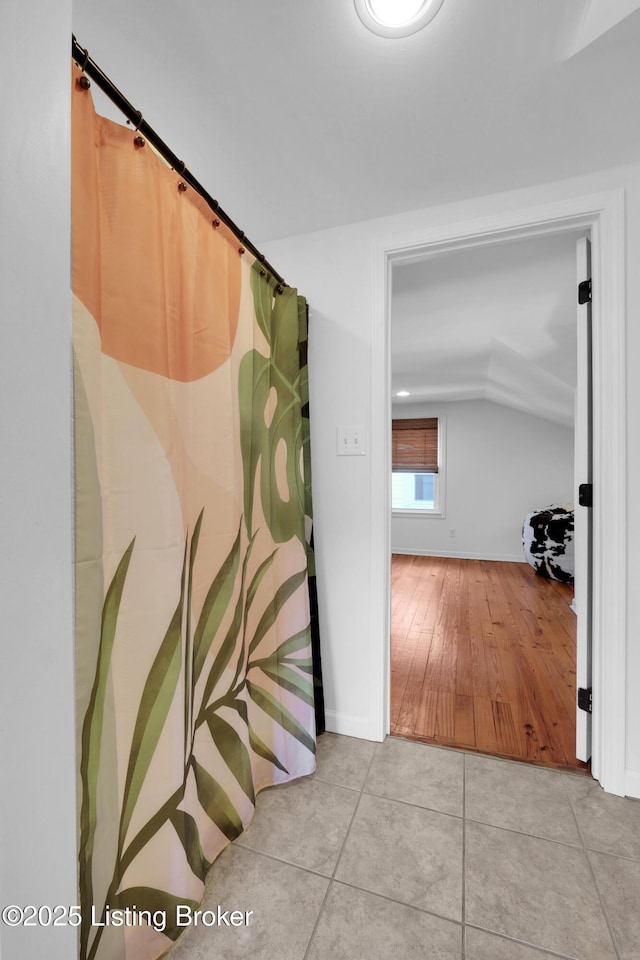 2410 Sherry Rd, Louisville, KY 40217 - corridor featuring vaulted ceiling, tile patterned floors, and baseboards