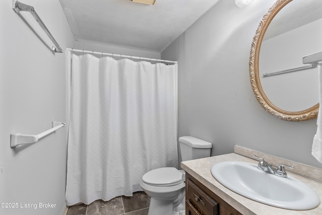 bathroom with toilet, vanity, a shower with curtain, and a textured ceiling