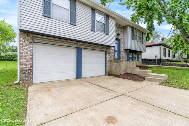 raised ranch with an attached garage, a front yard, driveway, and stone siding