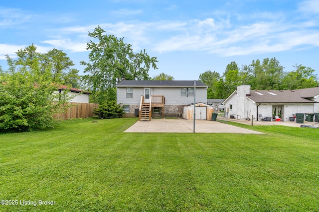 back of property with a storage unit, a patio area, an outdoor structure, and stone siding