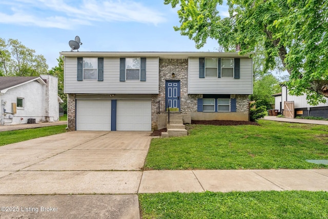 split foyer home with a garage, concrete driveway, a front lawn, and brick siding