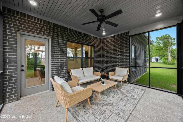 sunroom featuring ceiling fan and outdoor lounge area