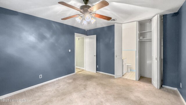 unfurnished bedroom featuring carpet, baseboards, a closet, and a ceiling fan