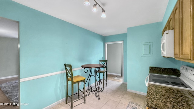 dining room featuring baseboards and light tile patterned floors