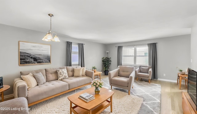 living room with light wood-type flooring and baseboards