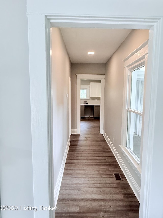 713 E Hill St, Louisville, KY 40217 - hallway featuring dark wood-type flooring and baseboards