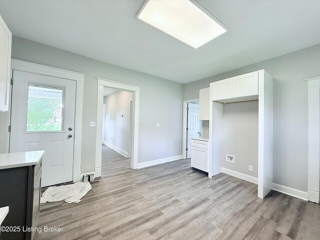 713 E Hill St, Louisville, KY 40217 - unfurnished bedroom featuring light wood-style floors and baseboards