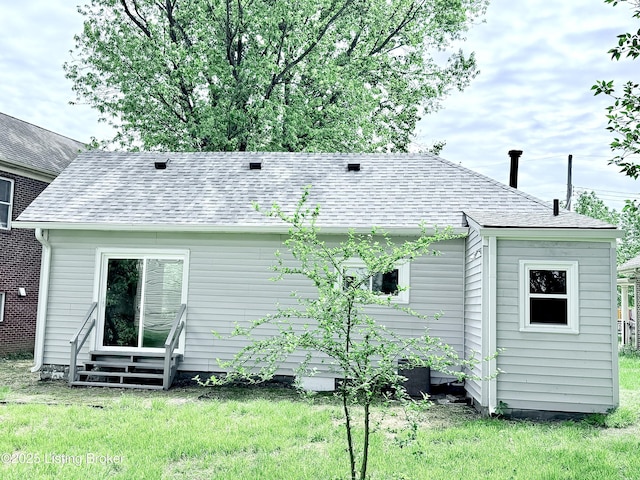 713 E Hill St, Louisville, KY 40217 - rear view of property with entry steps, a yard, and a shingled roof