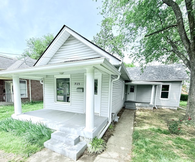 713 E Hill St, Louisville, KY 40217 - view of front facade with covered porch and roof with shingles