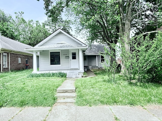 713 E Hill St, Louisville, KY 40217 - view of front of property featuring covered porch, a front lawn, and roof with shingles