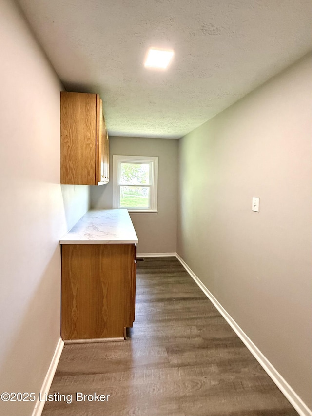 713 E Hill St, Louisville, KY 40217 - hall with dark wood-style flooring, baseboards, and a textured ceiling