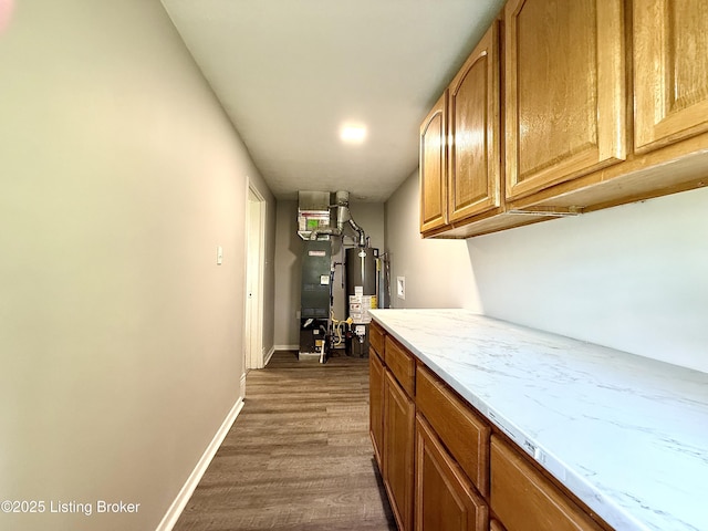 713 E Hill St, Louisville, KY 40217 - laundry room with gas water heater, dark wood-type flooring, heating unit, and baseboards