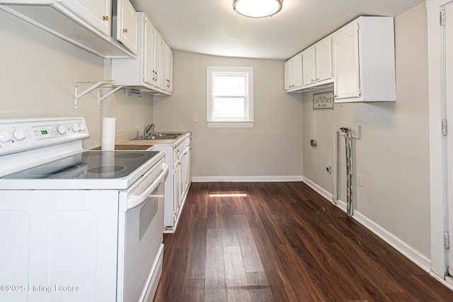 laundry area with dark wood-style floors and baseboards