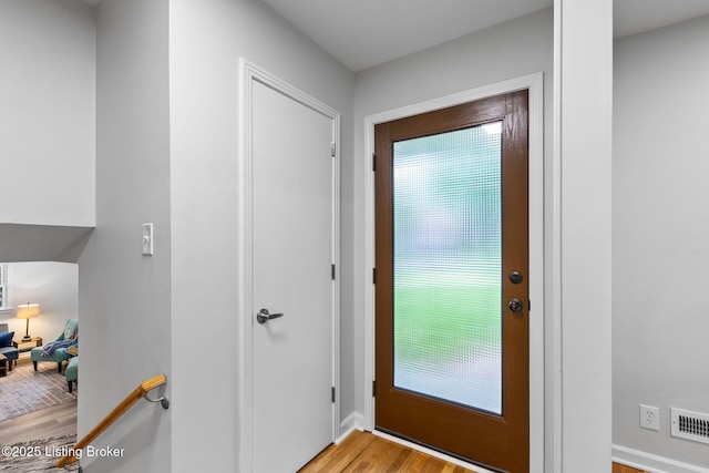 doorway to outside featuring light wood-style floors and baseboards