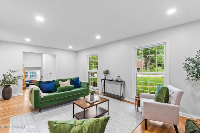 living area featuring wood finished floors, baseboards, and recessed lighting