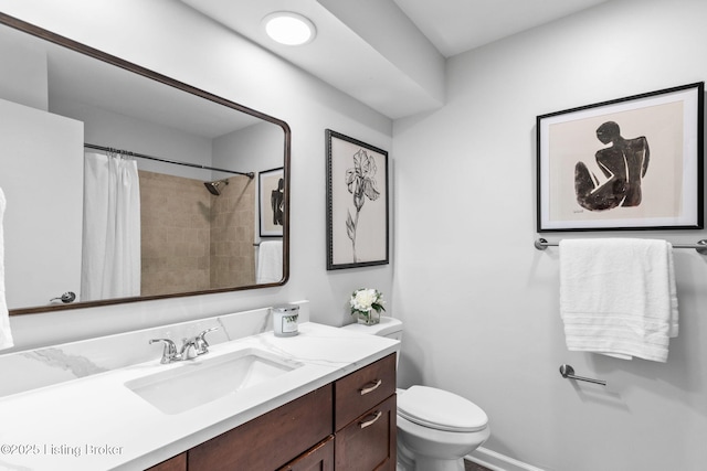 bathroom with toilet, vanity, and a shower with shower curtain