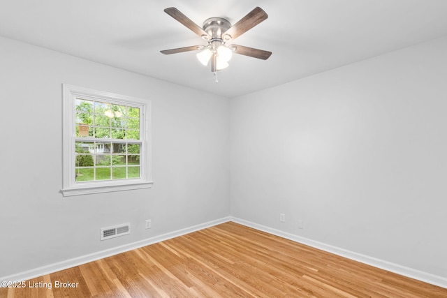 unfurnished room with light wood-style flooring, baseboards, and a ceiling fan