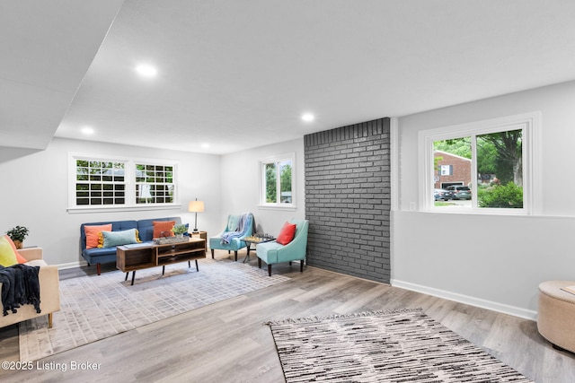 living room featuring wood finished floors, baseboards, and recessed lighting