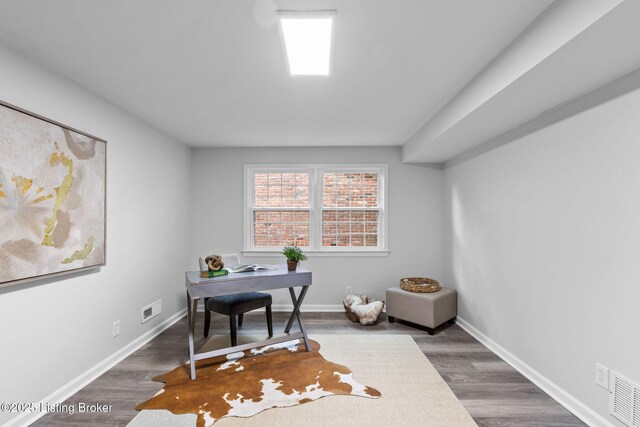 office space featuring wood finished floors and baseboards