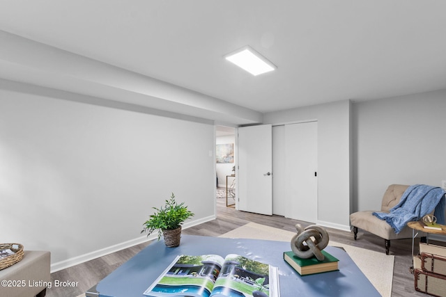 exercise area featuring wood finished floors and baseboards