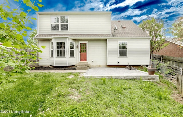 rear view of house featuring a patio area and a shingled roof