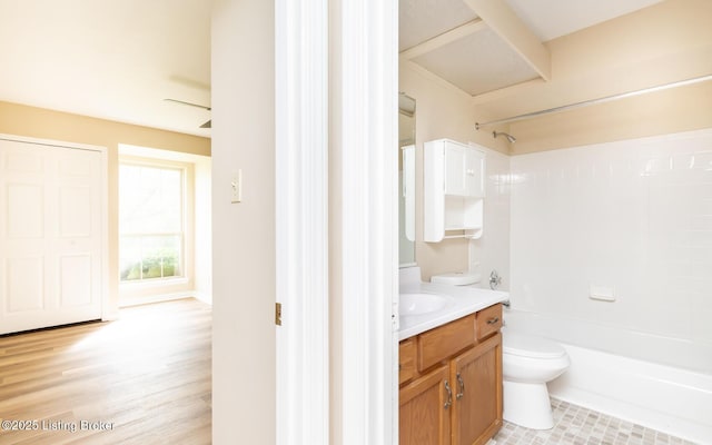 full bath with toilet, vanity, and  shower combination