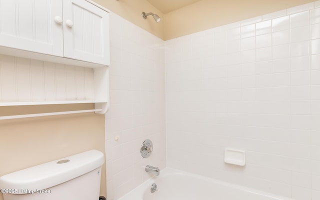 bathroom featuring shower / bath combination and toilet