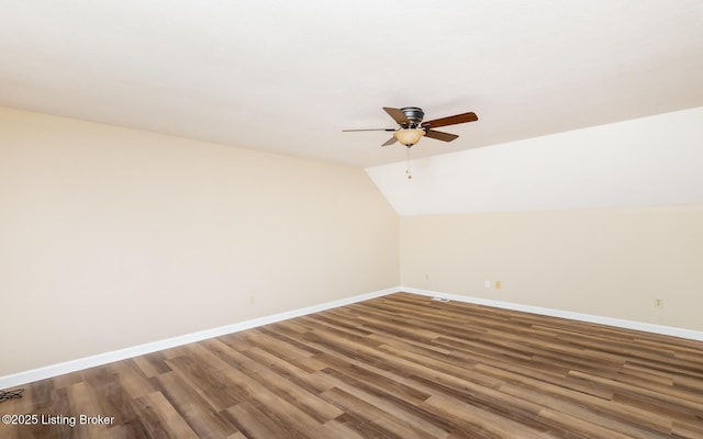 additional living space with a ceiling fan, baseboards, wood finished floors, and vaulted ceiling