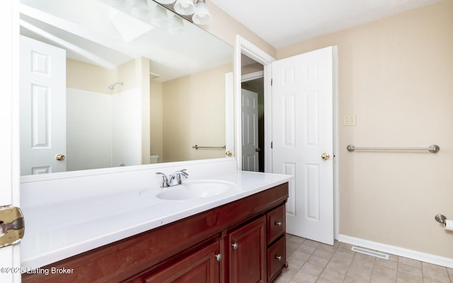 full bath with vanity, a shower, toilet, baseboards, and tile patterned floors
