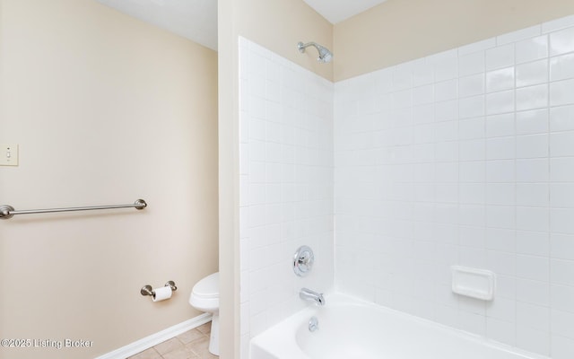 full bath with toilet,  shower combination, tile patterned flooring, and baseboards