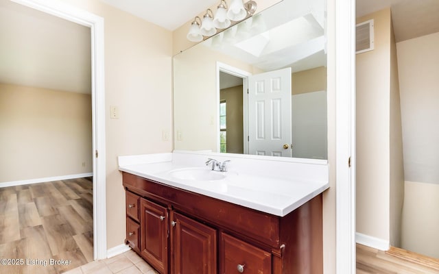 bathroom with vanity and baseboards