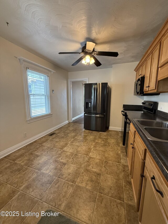 612 Ervay Ave, Louisville, KY 40217 - kitchen featuring black appliances, dark countertops, baseboards, brown cabinets, and ceiling fan