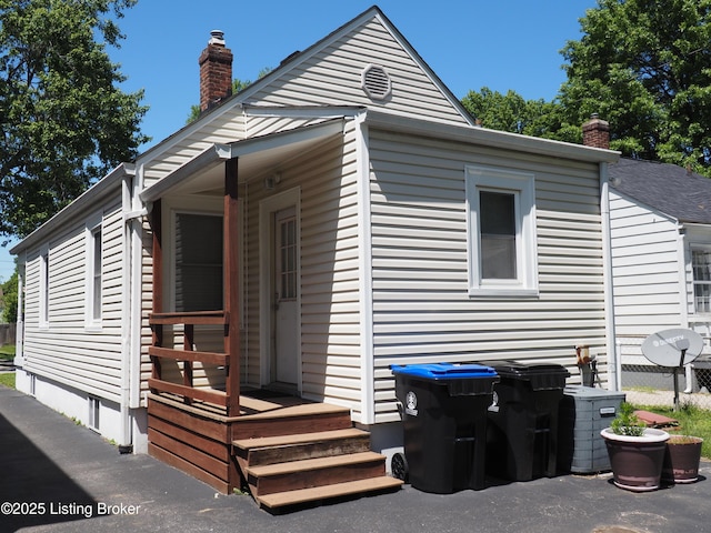 612 Ervay Ave, Louisville, KY 40217 - back of house with a chimney and fence
