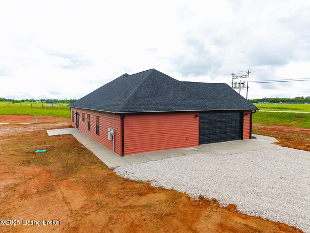 view of property exterior featuring roof with shingles