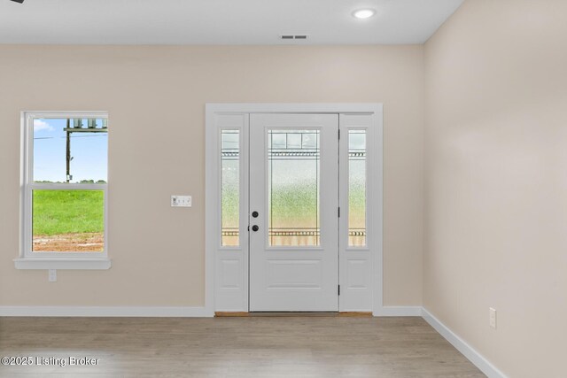 foyer entrance featuring healthy amount of natural light, baseboards, light wood-style floors, and recessed lighting