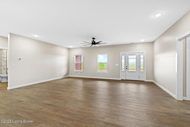 unfurnished living room featuring ceiling fan, wood finished floors, recessed lighting, and baseboards
