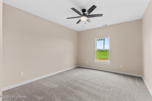 spare room featuring baseboards, carpet floors, and a ceiling fan