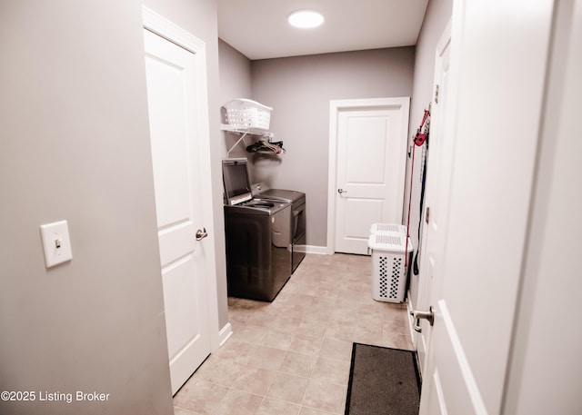 8812 Sanctuary Ln, Louisville, KY 40291 - laundry area featuring washing machine and dryer, light tile patterned floors, and baseboards