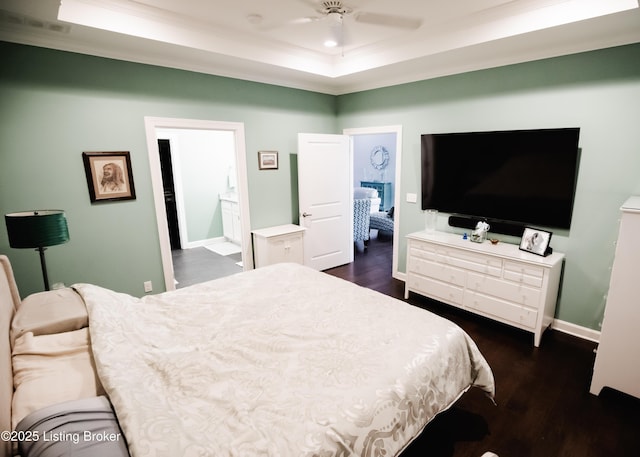 8812 Sanctuary Ln, Louisville, KY 40291 - bedroom with ornamental molding, a raised ceiling, dark wood-style floors, baseboards, and connected bathroom